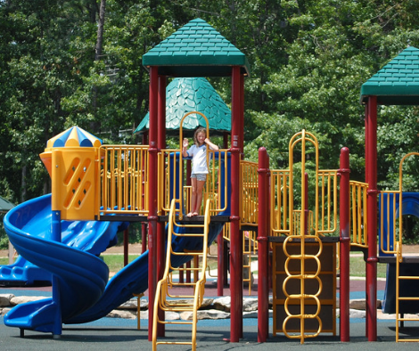 a girl using equipment at a play park