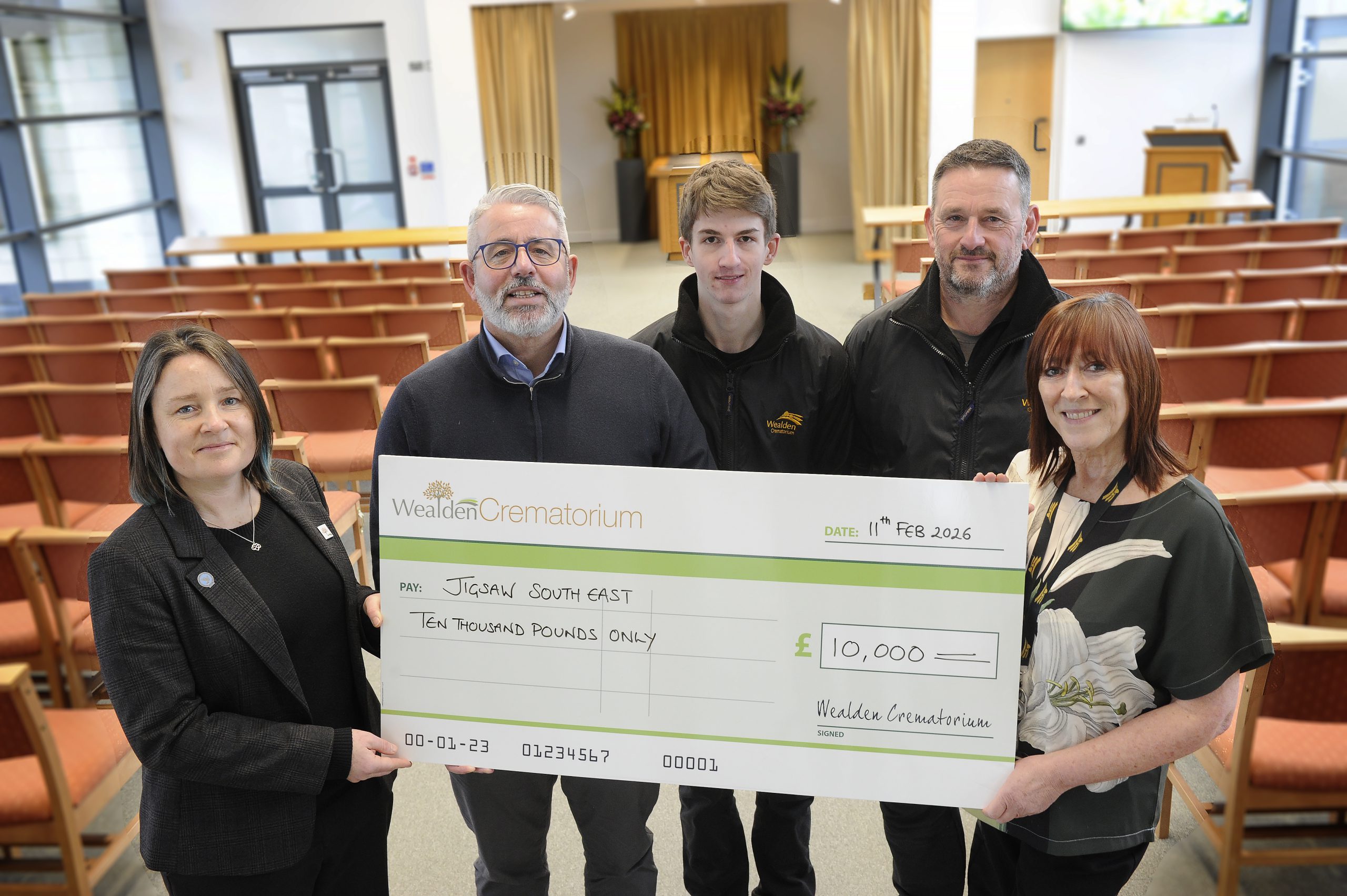 Staff at the crematorium with the team from Jigsaw South East holding the cheque
