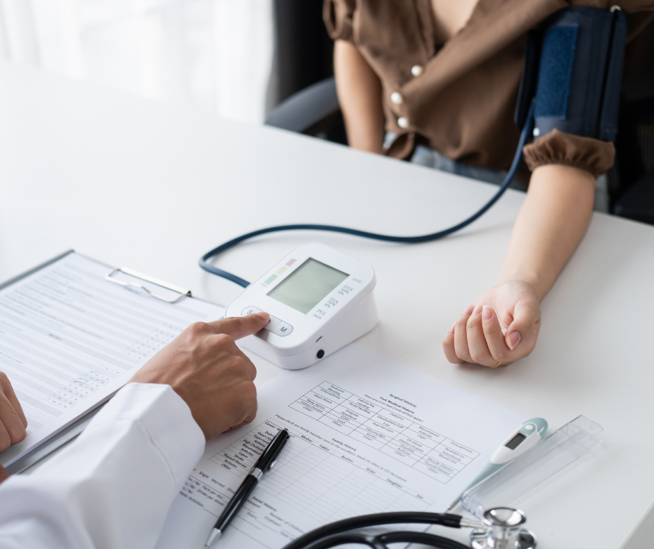 An image of a doctor checking a patients blood pressure